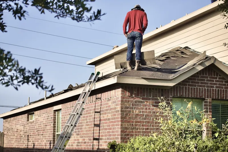 Professional roofer working on a residential roof in Society Meadows